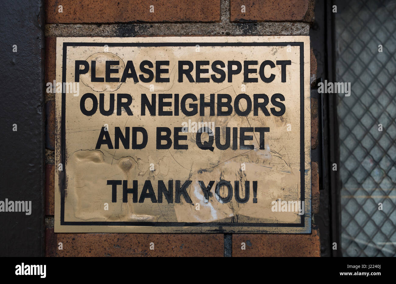 Old metal sign outside of a New York bar asking customers to be quiet Stock Photo