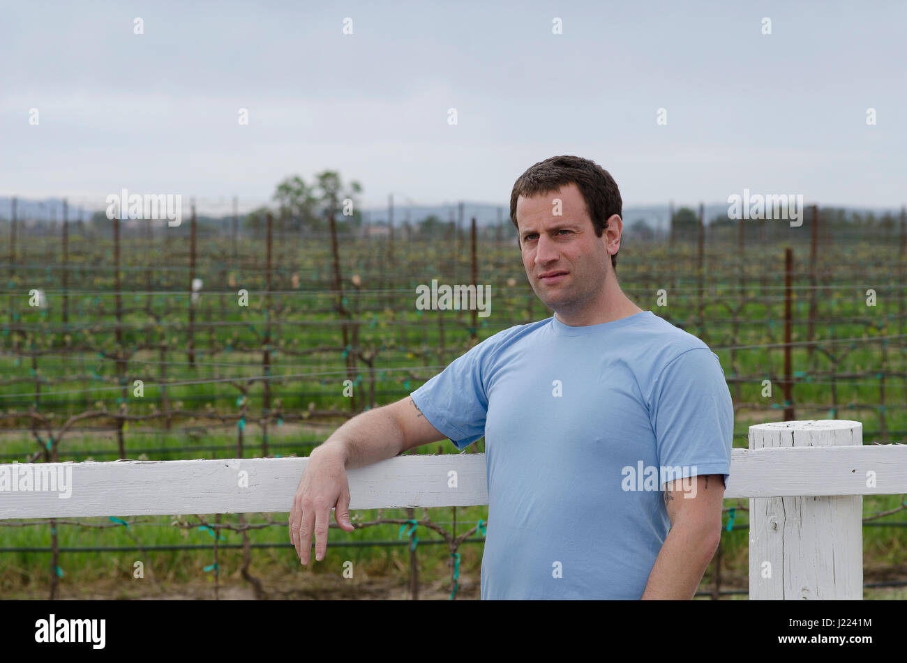 Man relaxing outside in a vineyard. Hopeful for tomorrow. Stock Photo