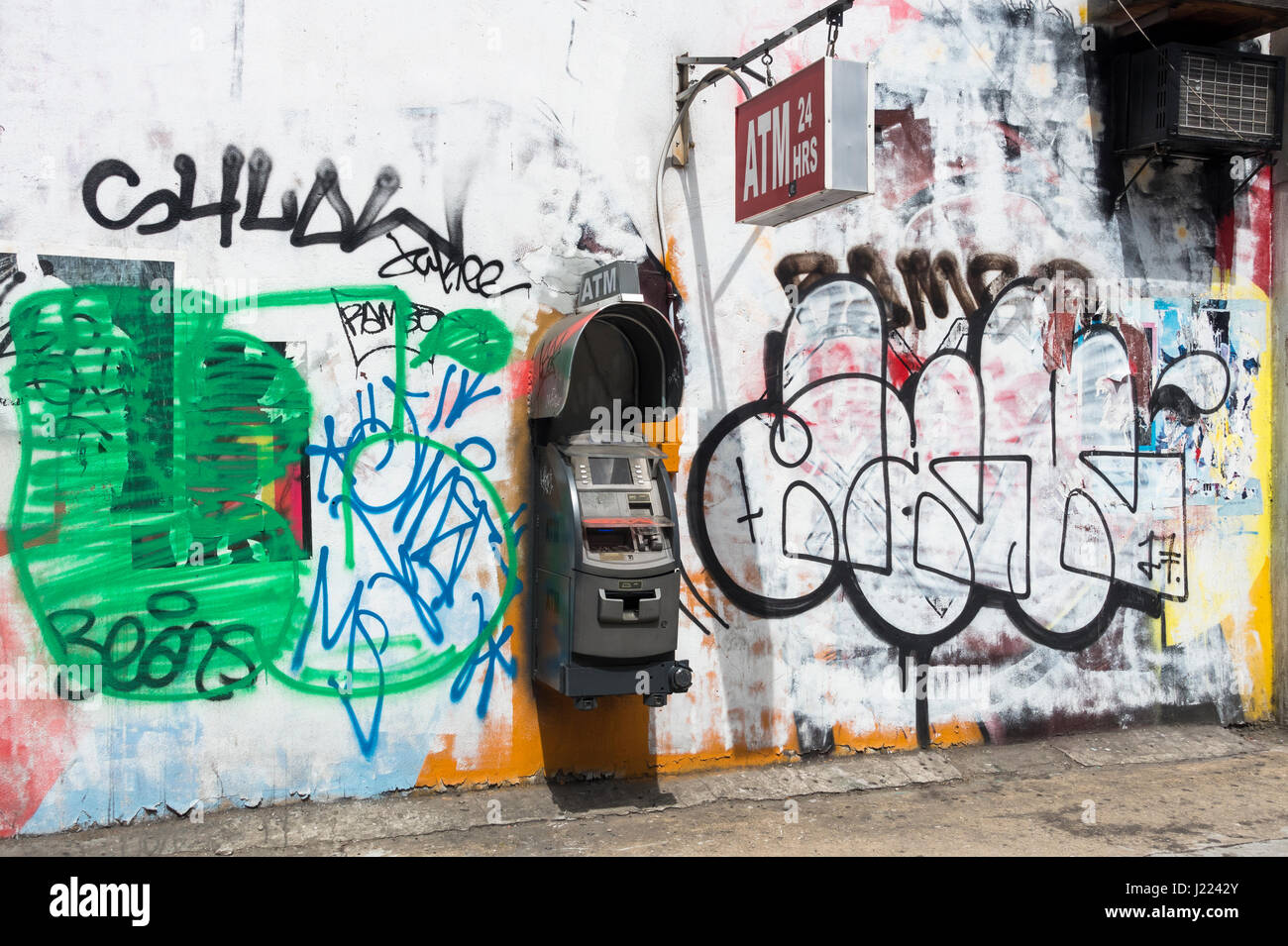 Privately owned ATM machine on the wall of a building in Lower Manhattan surrounded by graffiti Stock Photo