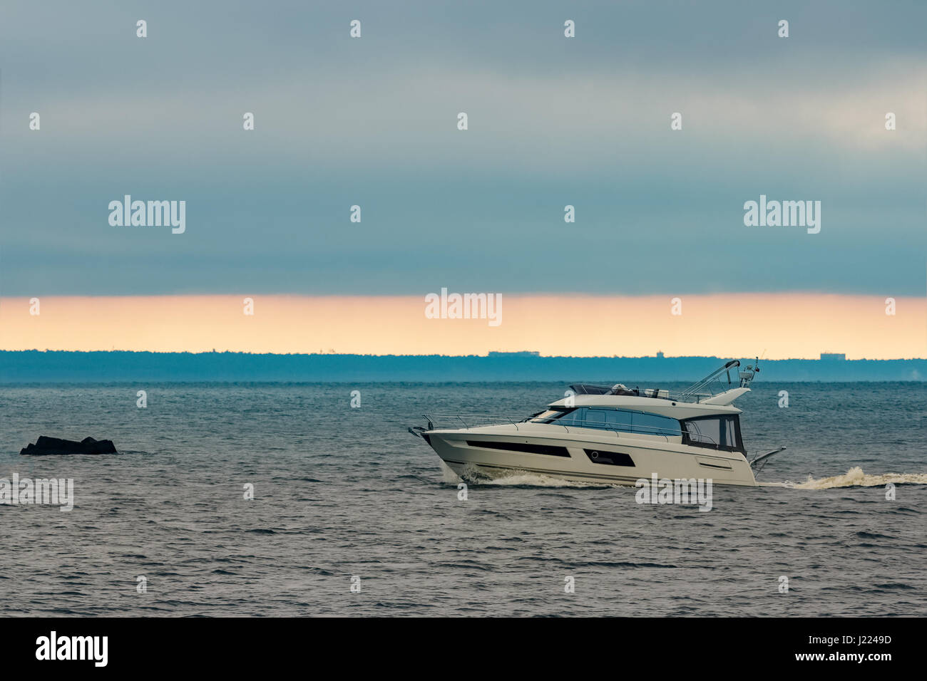 White small speed boat sailing in still water Stock Photo - Alamy