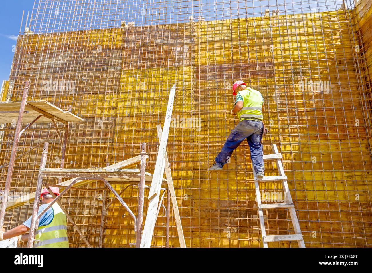 Construction worker is binding rebar for tall reinforced concrete