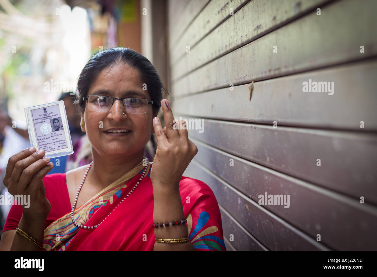 New Delhi - APRIL 23, 2017: New Delhi elections 2017 A woman shows her ink stained index finger after casting her vote for the MCD elections 2017. Stock Photo