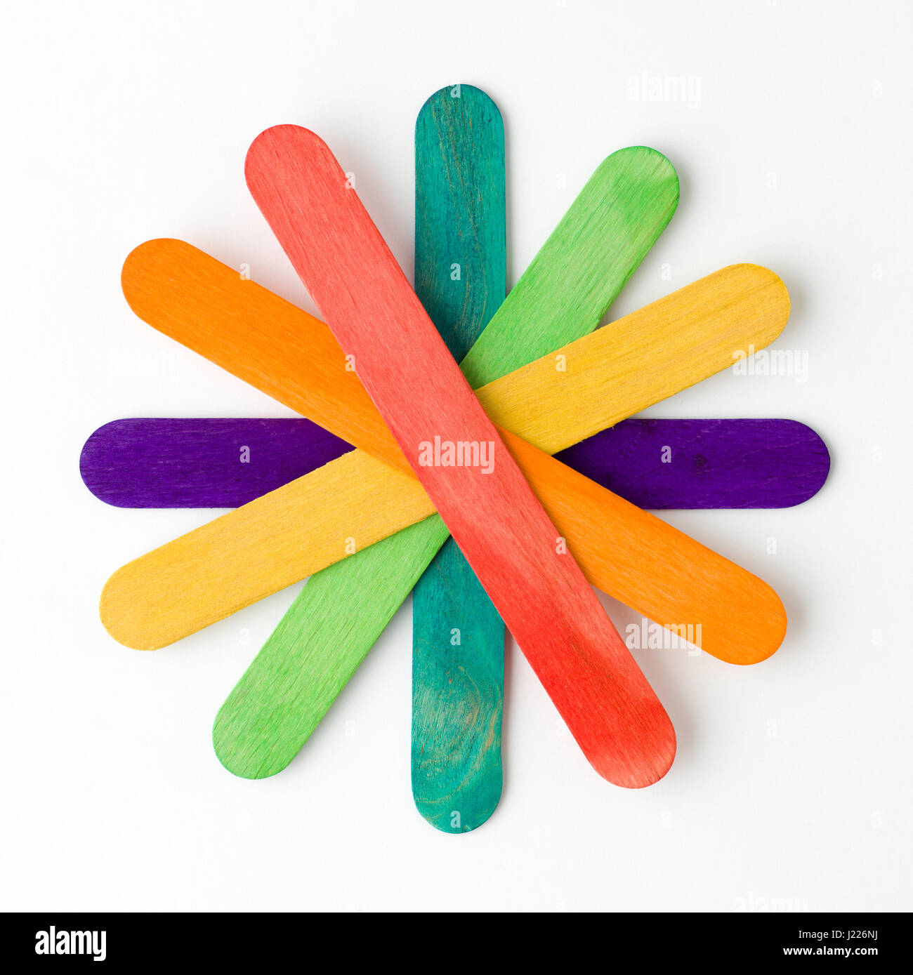 Flower shape arranged colorful wooden tongue depressors on white