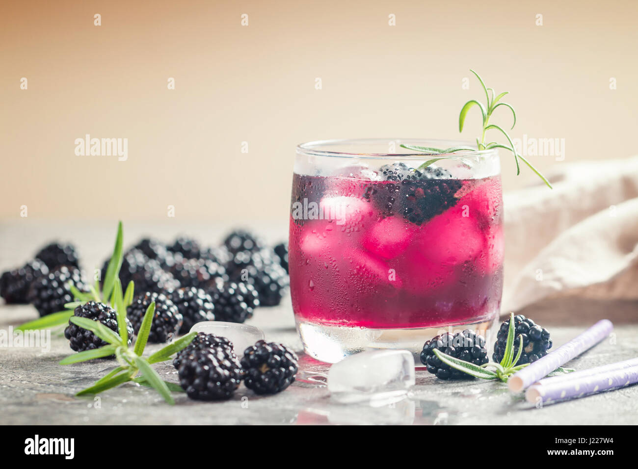 Refreshing lemonade with blackberry, ice and rosemary Stock Photo - Alamy