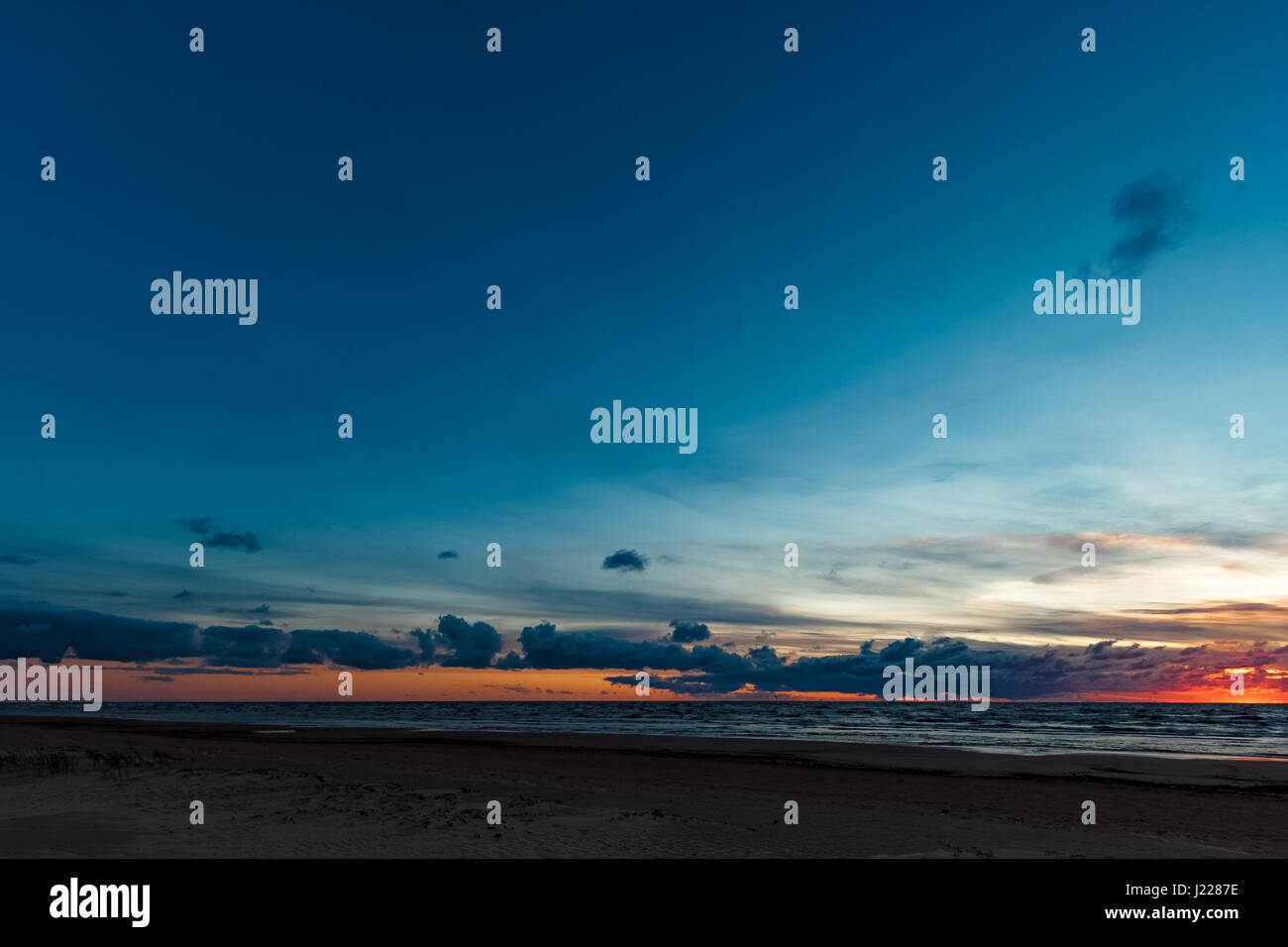 Blue cloudy sky over the Baltic sea at evening Stock Photo - Alamy