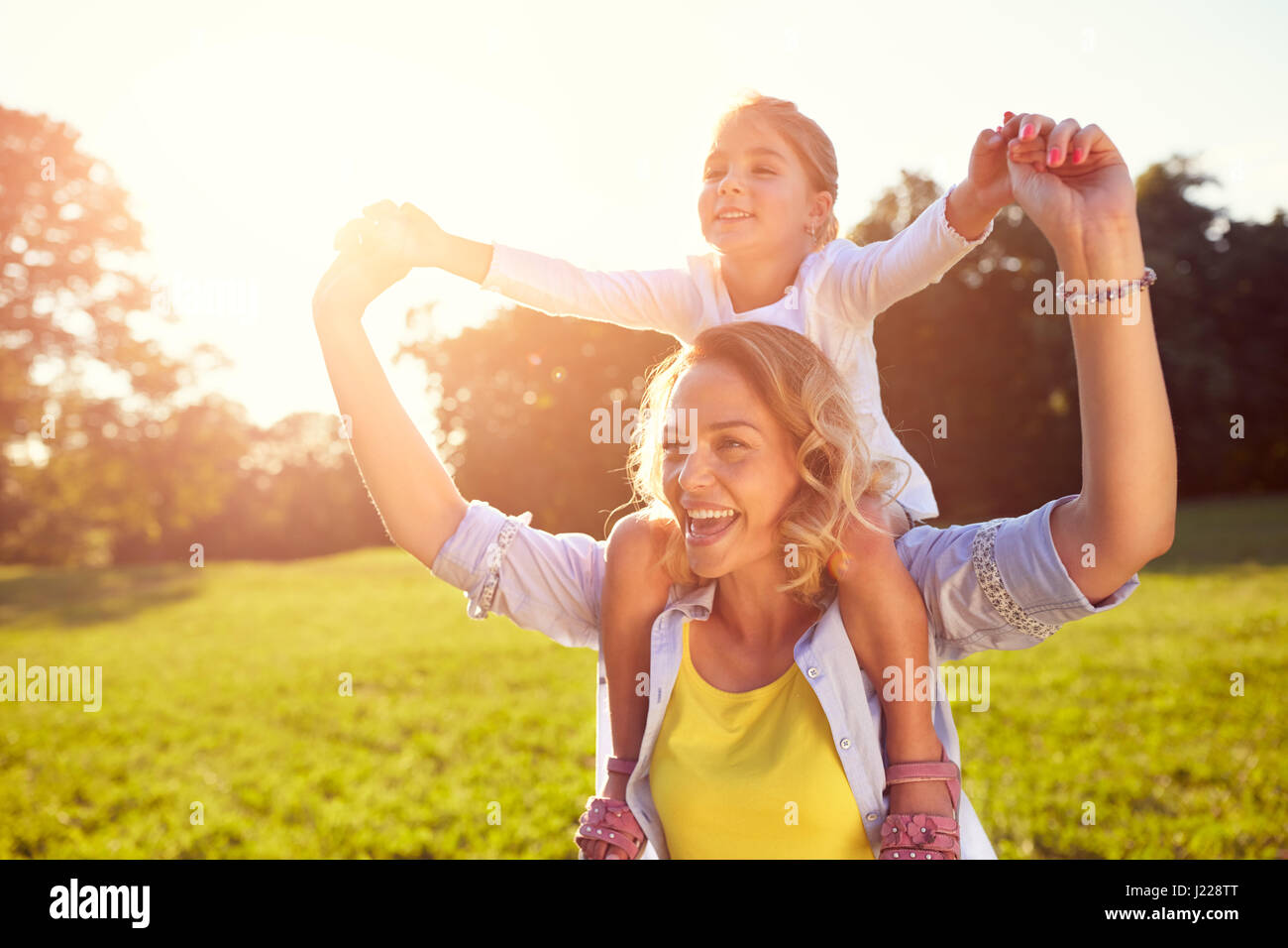young-woman-with-girl-on-shoulders-outside-stock-photo-alamy