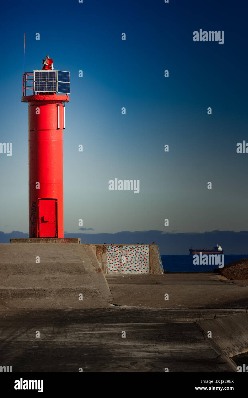 Red lighthouse on breakwater dam in Riga, Europe Stock Photo