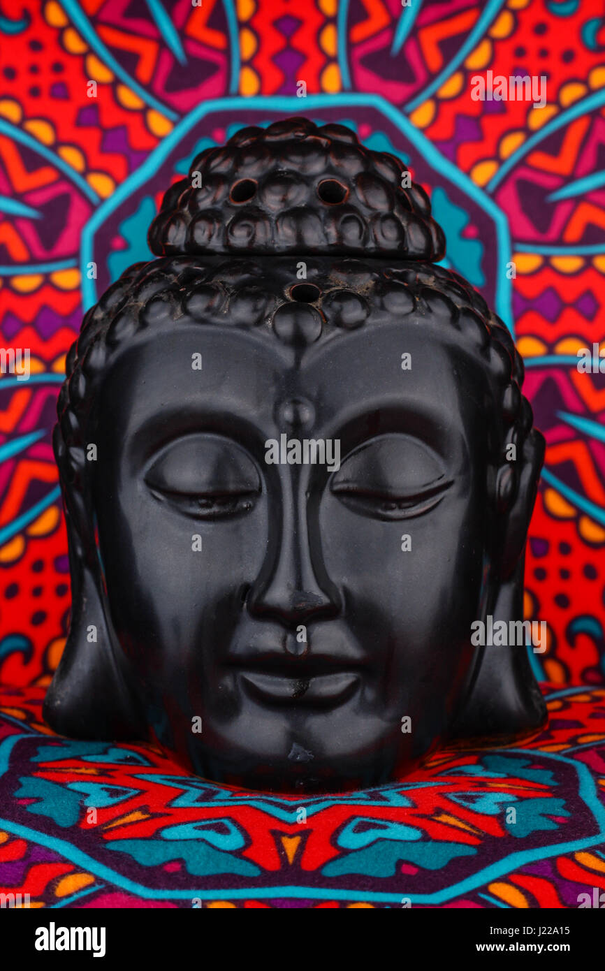 Buddha statue on a colorful background / featuring a wooden statue of