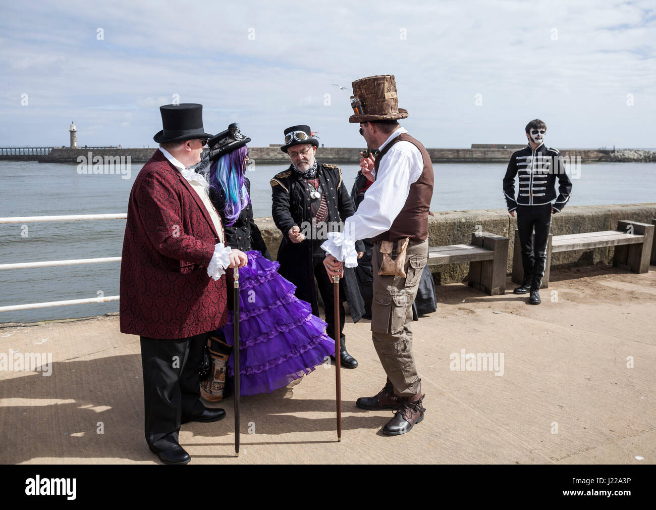 A group of people dressed in Steampunk fashion chat together on the quayside at Whitby at the Goth Weekend celebrations,North Yorkshire,England,UK Stock Photo