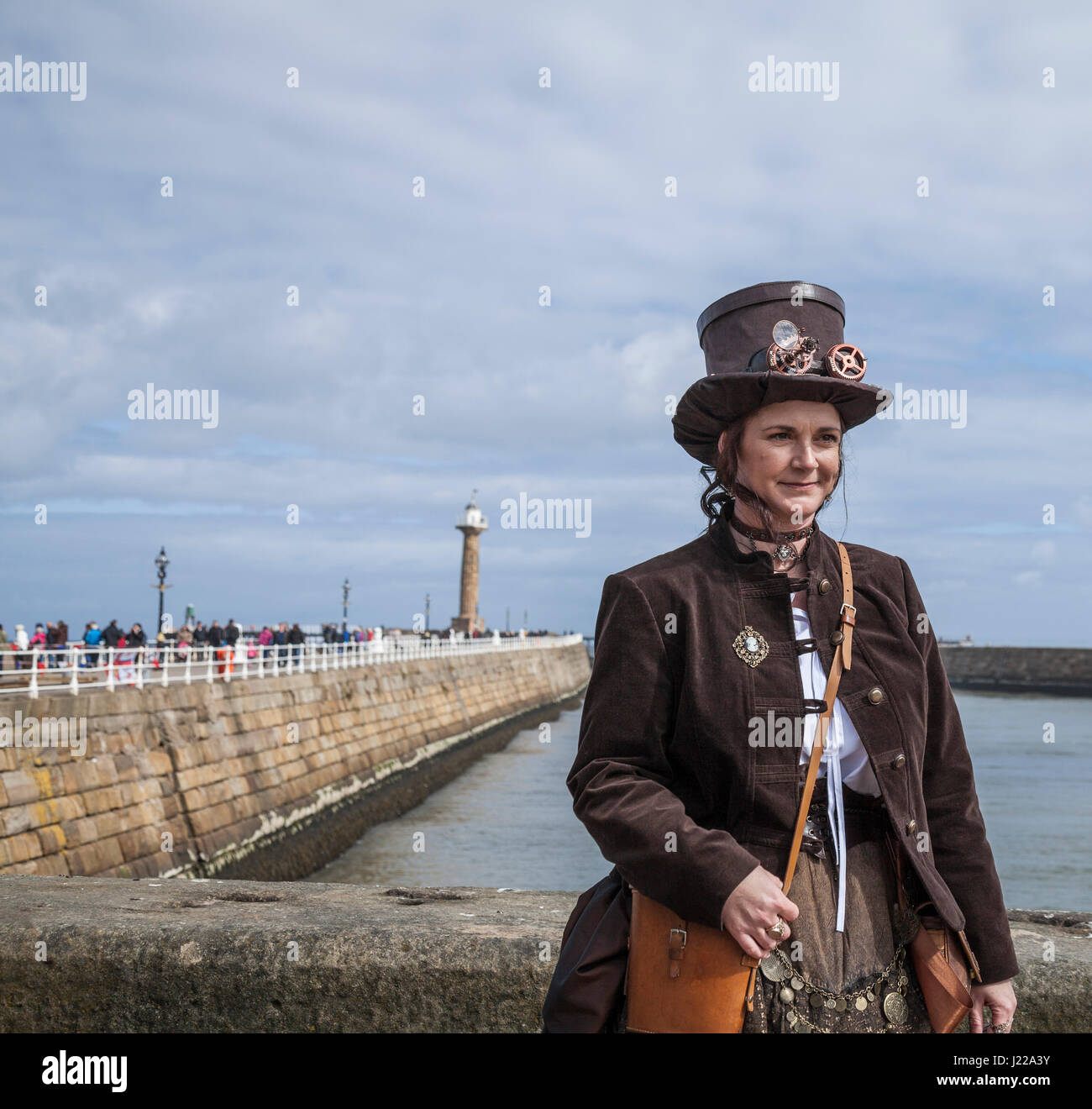 An attractive woman Steampunk poses for photos at the harbour in Whitby,North Yorkshire ,England,UK at the Goth Weekend celebrations Stock Photo