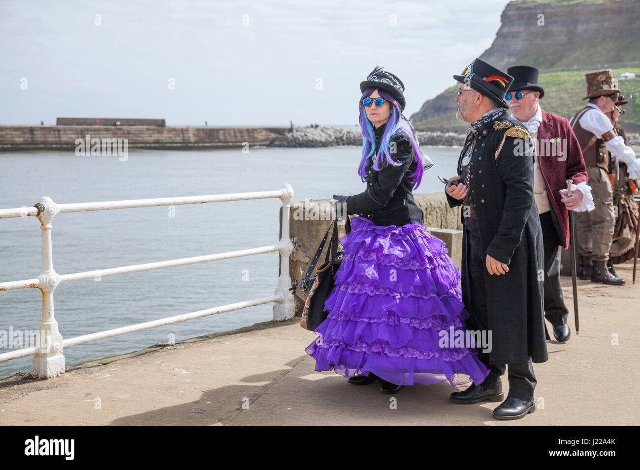 A group of people dressed in Steampunk fashion chat together on the quayside at Whitby at the Goth Weekend celebrations,North Yorkshire,England,UK Stock Photo