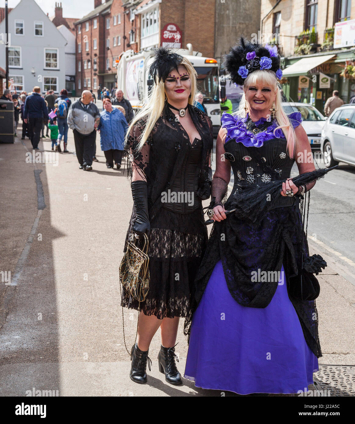 Two women pose for photos at the Whitby Goth celebrations in North Yorkshire,England,UK Stock Photo