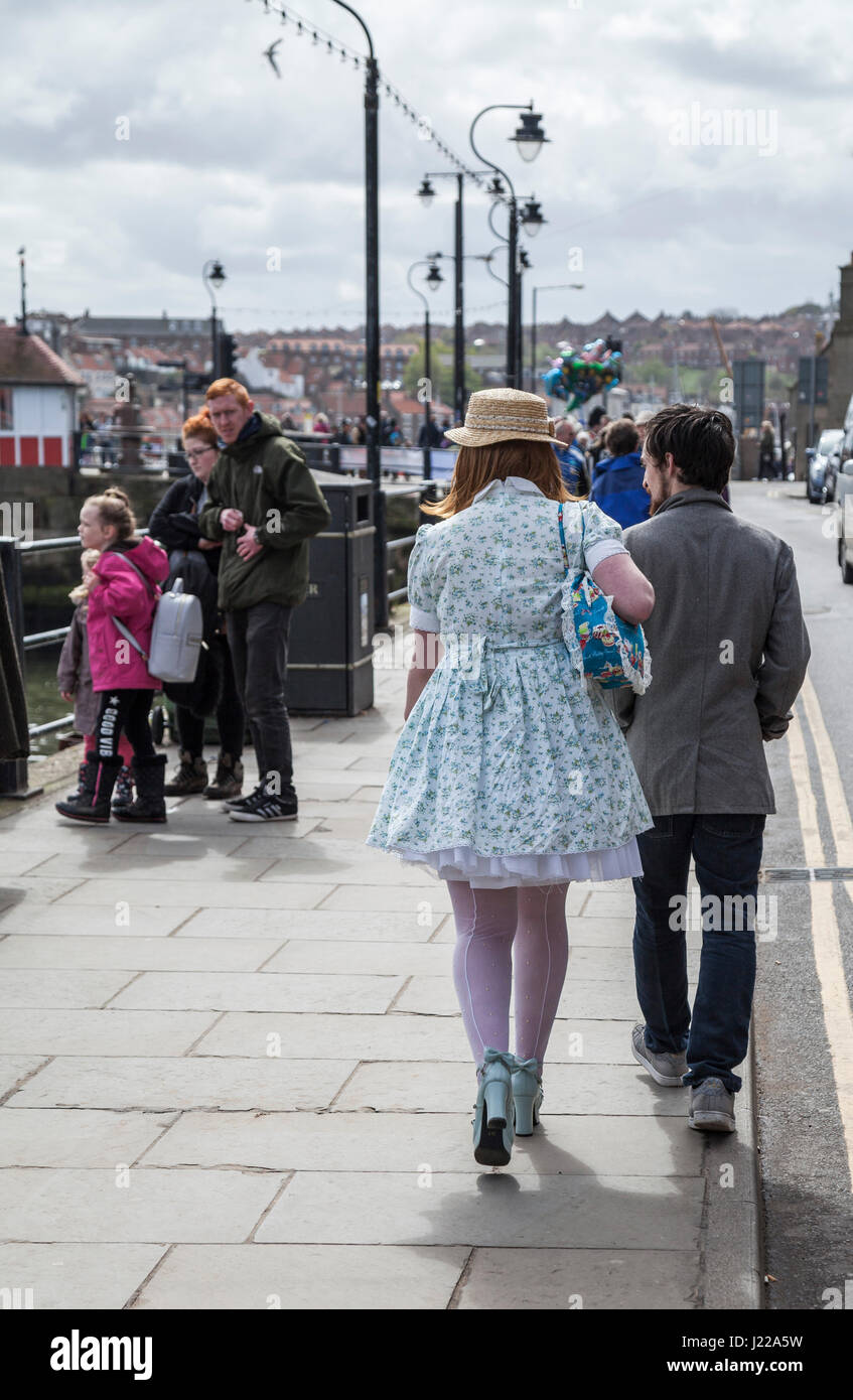 A young couple dressed for the Whitby Goth celebrations at North Yorkshire,England,UK walk along the promenade Stock Photo