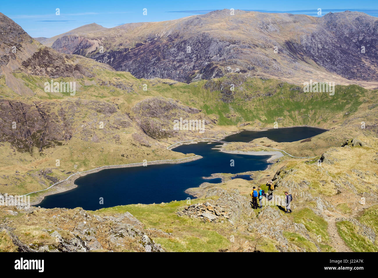 High view to Llyn Llydaw lake from slopes of Y Lliwedd in Snowdon Horseshoe with hikers in mountains of Snowdonia National Park. Gwynedd, Wales, UK Stock Photo