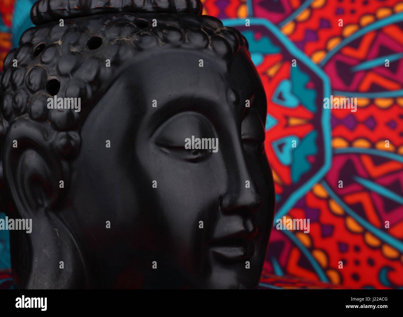 Buddha statue on a colorful background / featuring a wooden statue of