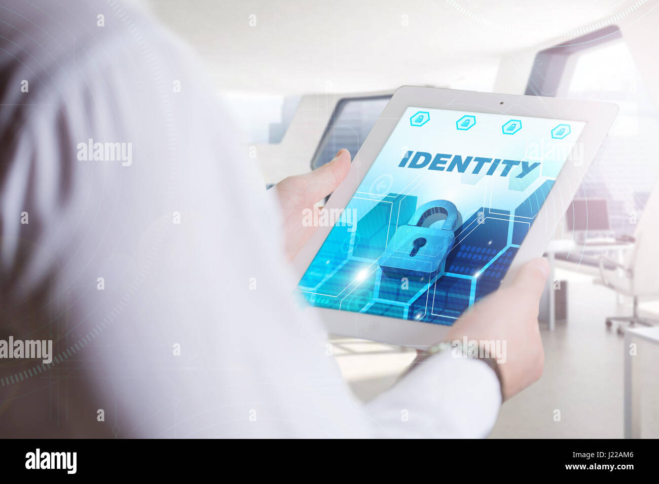 Business, Technology, Internet and network concept. Young business man, working on the tablet of the future, select on the virtual display: Identity Stock Photo