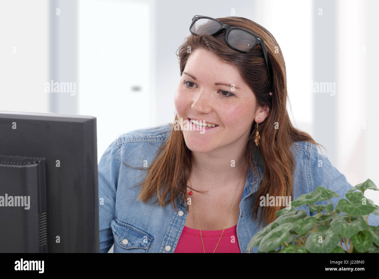 pretty young business woman working at pc in her office Stock Photo - Alamy