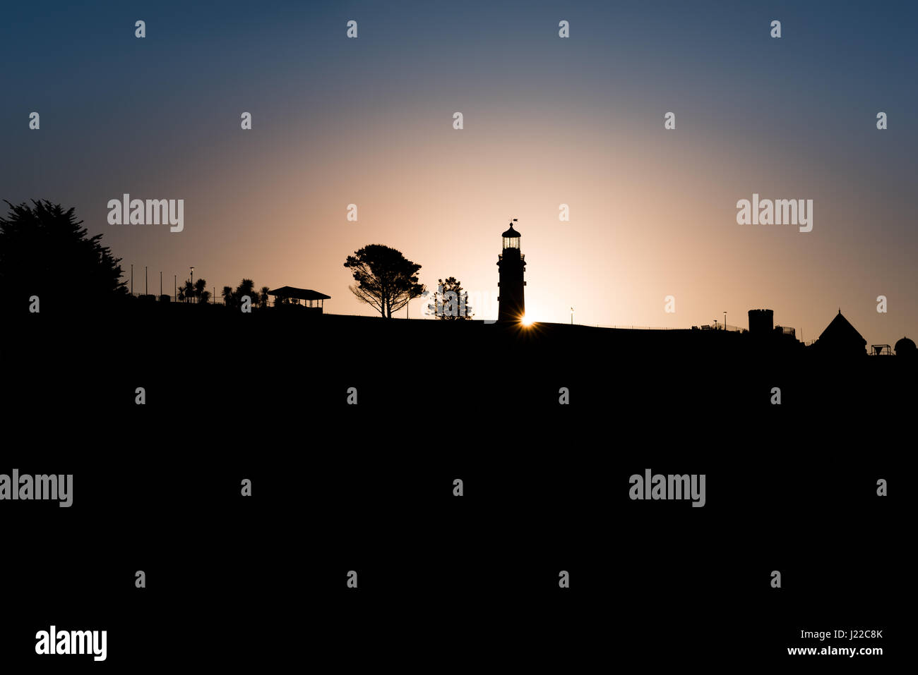 The iconic landmark, Smeatons Tower, stands out on the Plymouth Hoe skyline against the April dawn in Devon England. Stock Photo