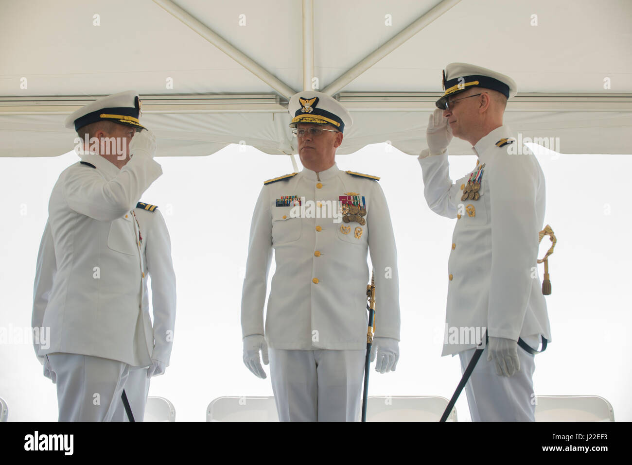 Capt. Jeffrey Dixon, left, transfers command of Coast Guard Sector
