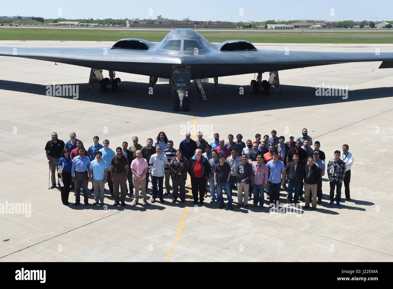 Group photo showing U.S. Air Force civilian and contractor employees in front of B-2A, serial #88-0331, 'Spirit of South Carolina' of the 509th Bomb Wing, Air Force Global Strike Command, on the parking ramp at Tinker Air Force Base, Oklahoma, during a visit April 11, 2017. The B-2A 'stealth bomber' visited the base to allow hundreds of personnel who work in direct support of the aircraft program through continuous software upgrades to see it in person and better understand the aircrafts' role in the nation’s defense. (U.S. Air Force photo/Greg L. Davis) Stock Photo