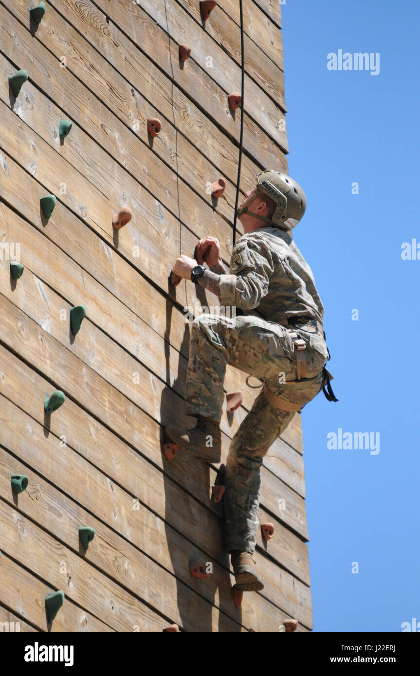 Staff Sgt. Luke Katz scales a rock wall tower during the day stakes portion of the Best Ranger Competition at Fort Benning, Ga. The competition was held April 7-9. Katz, a member of the Nebraska Army National Guard, finished the competition in 10th place, improving on his 17th place finish the previous year. (Nebraska National Guard photo by Sgt. Jason Drager) Stock Photo