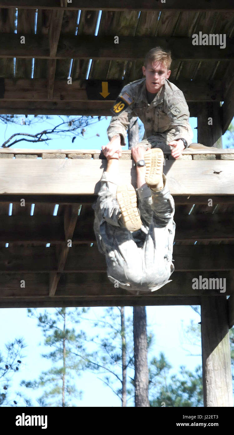 Staff Sgt. Luke Katz pulls his teammate, Sgt. 1st Class Troy Conrad, up a structure at the Darby Queen obstacle course in Fort Benning, Ga. The Darby Queen was one of the 26 tasks that made up the Best Ranger Competition, which was held April 7-9. Katz, a member of the Nebraska Army National Guard, competed for his second consecutive year and finished 10th overall. (Nebraska National Guard photo by Sgt. Jason Drager) Stock Photo