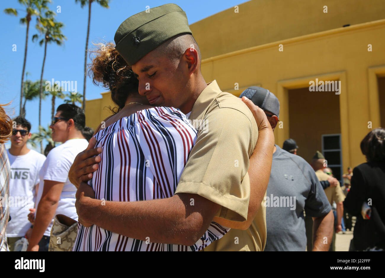 The new Marines of Golf Company, 2nd Recruit Training Battalion, embrace their loved ones during liberty call at Marine Corps Recruit Depot San Diego, today.  After nearly thirteen weeks of training, the Marines of Golf Company will officially graduate from recruit training tomorrow. Stock Photo