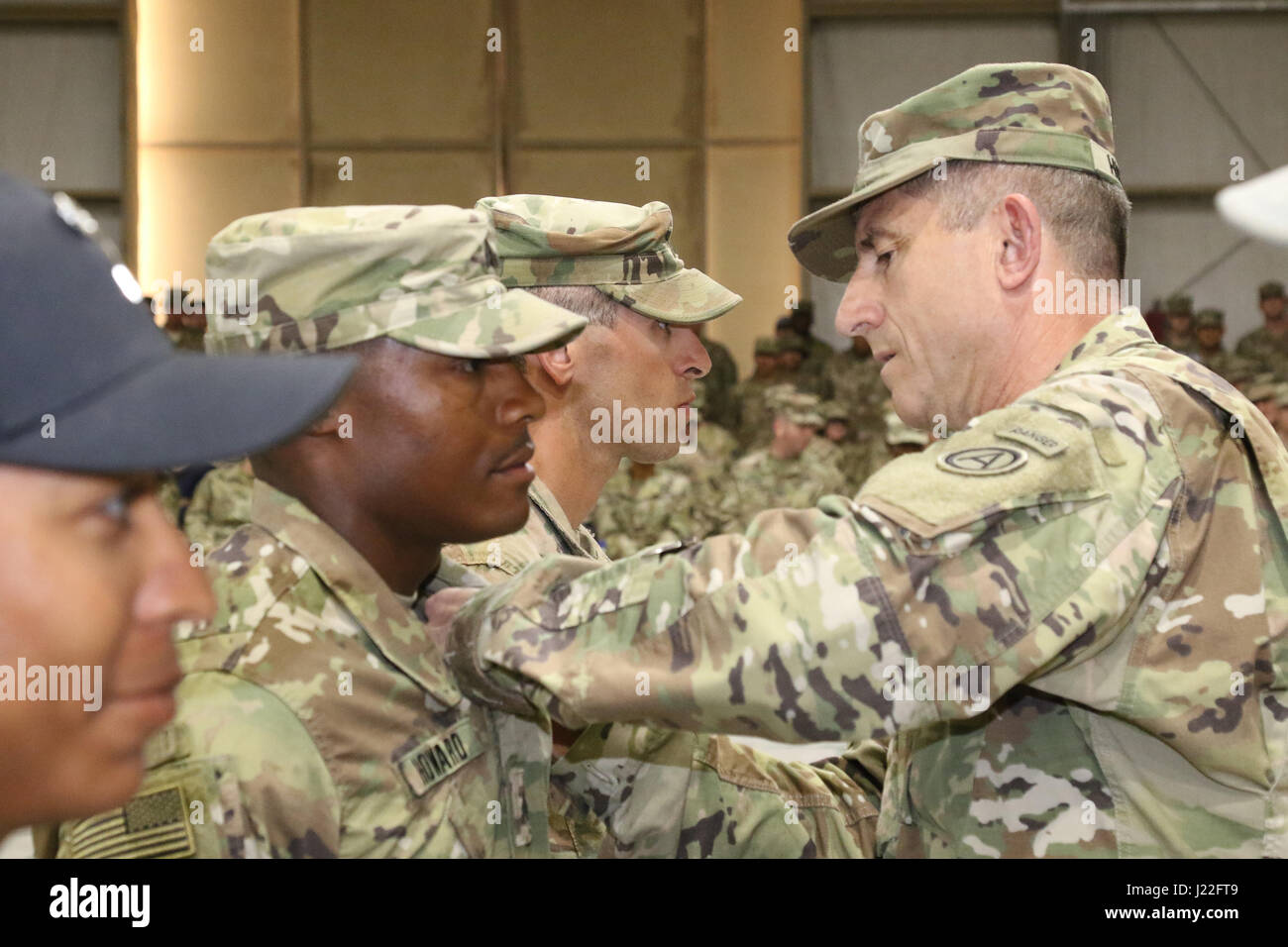 U.S. Army Maj. Gen. William Hickman (right), deputy commanding general of U.S. Army Central, pins air assault wings on one of the Air Assault Course’s honor graduates Sgt. Carl Howard, combat medic, 215th Brigade Support Battalion, 3rd Armored Brigade Combat Team, 1st Cavalry Division, during graduation day, April 14, 2017, at Camp Beuhring, Kuwait. The Air Assault Course is a 12-day class that allows U.S. military personnel in the U.S. Army Central area of operations the unique opportunity to become air assault qualified, while deployed outside the continental United States. Stock Photo