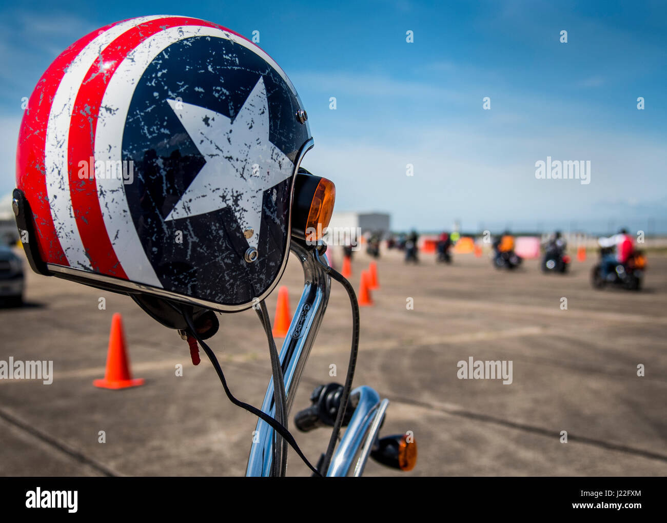A bike and helmet wait for their rider as people roll out after the annual motorcycle safety rally at Eglin Air Force Base, Fla., April 14.  More than 500 motorcyclists came out for the event that meets the annual safety briefing requirement for base riders.  (U.S. Air Force photo/Samuel King Jr.) Stock Photo