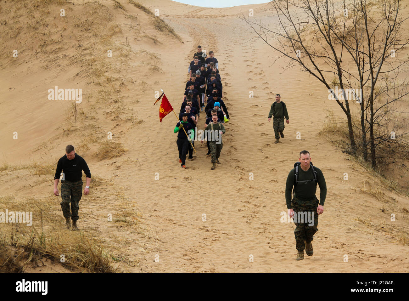 Future Marines hike with U.S. Marine Corps Maj. Christopher Hart, right