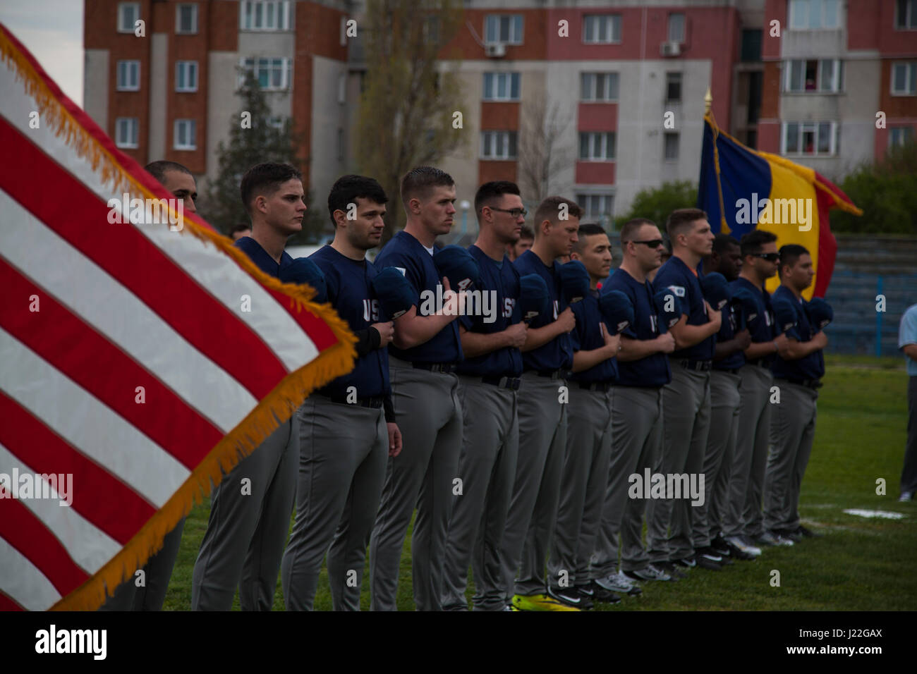 U.S. Marines with the Black Sea Rotational Force 17.1 stand for the National Anthem at the Jackie Robinson Day baseball game between the U.S. Marines and a Romanian team in Constanta, Romania April 15, 2017. The Marine and Romanian players all wore the number 42 jersey in honor of the 70th anniversary of Robinson becoming the first African American player in the Major League Baseball history. (U.S. Marine Corps photo by Cpl. Emily Dorumsgaard) Stock Photo