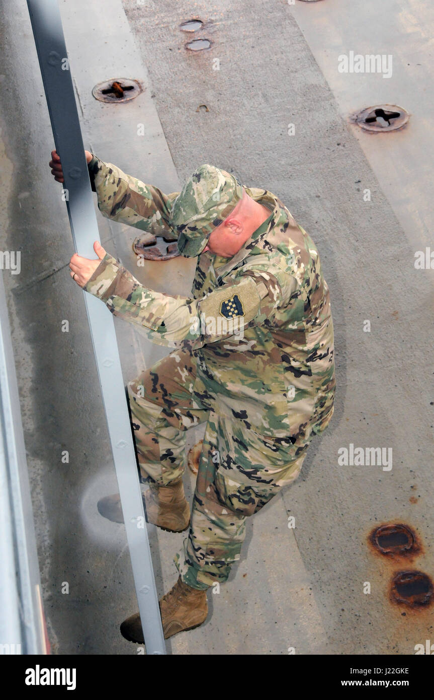 Maj. Gen. Troy D. Kok, commanding general for the U.S. Army Reserve’s 99th Regional Support Command, climbs down into the cargo area of the Major General Robert Smalls (LSV-8) April 17 at Area Maintenance Support Activity 83 at Curtis Bay, Maryland.  AMSA 83 is one of two locations in the 99th Regional Support Command’s footprint that maintain watercraft.  The AMSA provides technical assistance and maintenance support to the 949th Transportation Company along with the 203rd Transportation Detachment. Stock Photo