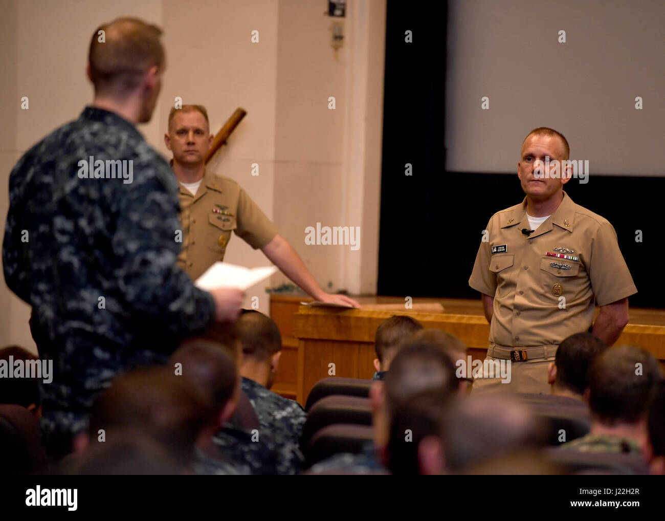 170417-N-LQ926-083 OAK HARBOR, Wash. (April 17, 2017) Master Chief Petty Officer of the Navy (MCPON) Steven S. Giordano takes a question from the audience during an all-hands call with Sailors at the base theater on Naval Air Station Whidbey Island, as part of a fleet engagement trip to Navy Region Northwest (NRNW). MCPON Giordano, the 14th MCPON, visited Navy Region Northwest commands and installations to talk with Sailors and senior enlisted leaders April 17, 18 and 19. NRNW is the third largest fleet concentration in the continental United States, supporting the fleet, fighter and family in Stock Photo