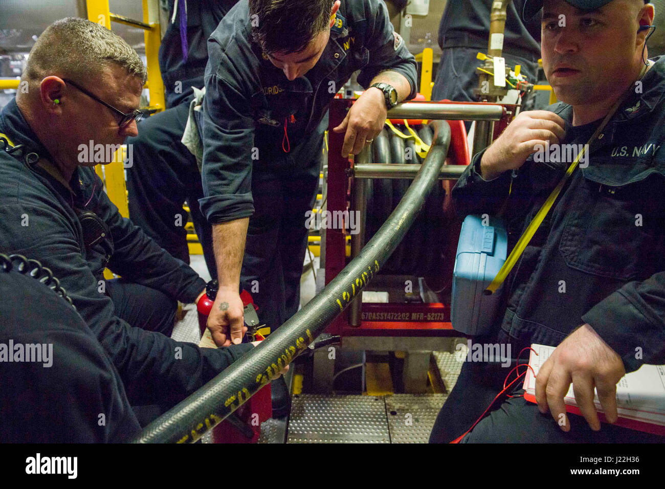 170417-N-PD309-033 CHANGI NAVAL BASE, Singapore (April 17, 2017) Senior Chief Gas Turbine Systems Technician James Richards, left, and Damage Controlman 3rd Class John Murphy, right,  participate in drills with Chief Machinist's Mate Caleb Aldridge, a member of the Engineering Training Team with Commander, Littoral Combat Ship Squadron One, in preparation for Engineering Operations Certification aboard littoral combat ship USS Coronado (LCS 4). Coronado is on a rotational deployment in U.S. 7th Fleet area of responsibility, patrolling the region's littorals and working hull-to-hull with partne Stock Photo