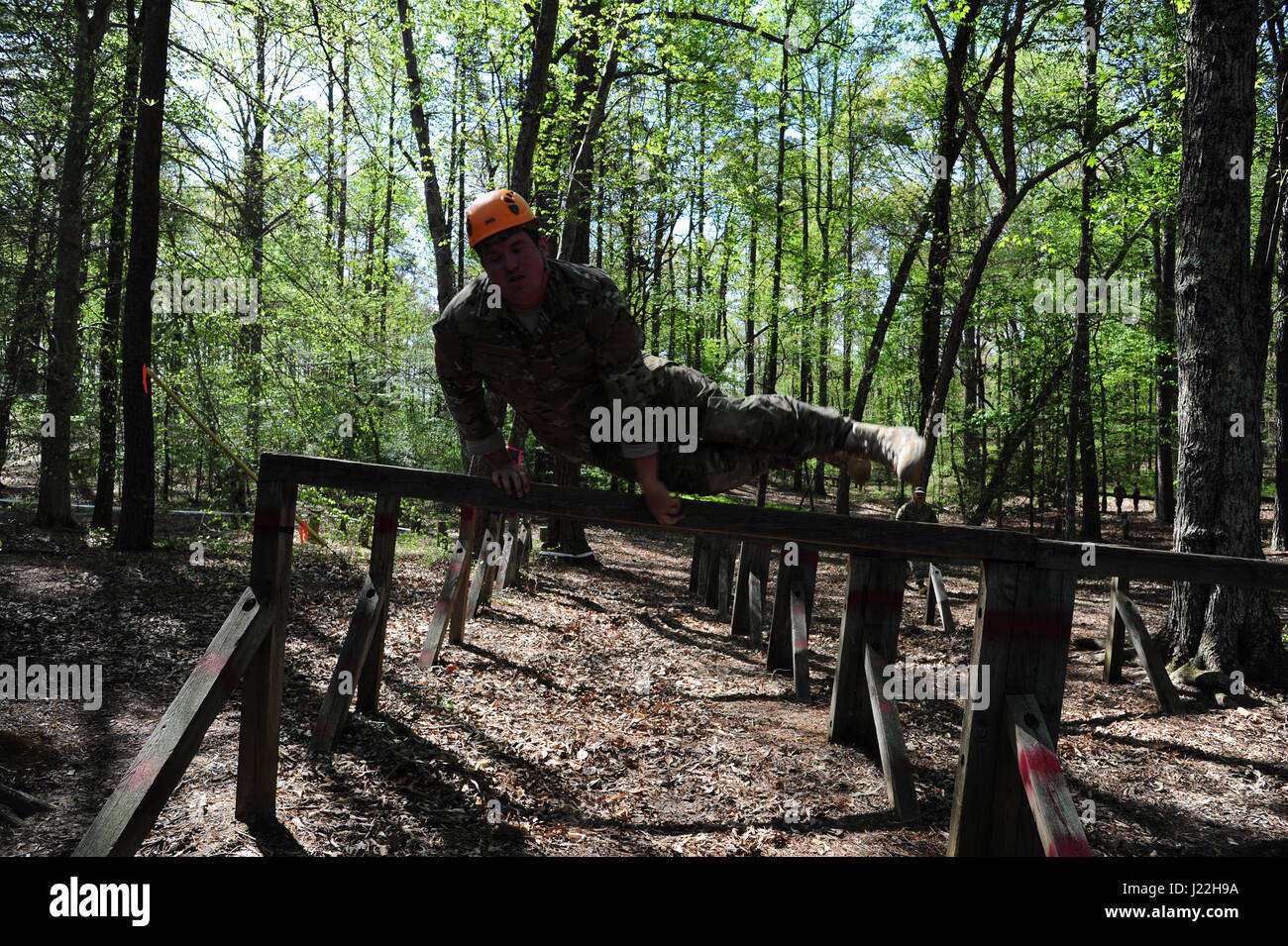 U.S. Air Force Airman 1st Class Kyle Hagan, a Combat Photographer, assigned to the 1st Combat Camera Squadron, vaults over the final obstacle of a combat obstacle course as part of the 2017 5th Annual SPC Hilda I. Clayton Best Combat Camera (COMCAM) Competition at Fort George G. Meade, Md., April 18, 2017. The obstacle course is conducted on day two of the Spc. Hilda I. Clayton Best COMCAM Competition, which is designed to build self-confidence and teamwork by taking members out of their comfort zones.  The obstacle course is the fourth event of the competition, in which teams of two compete t Stock Photo