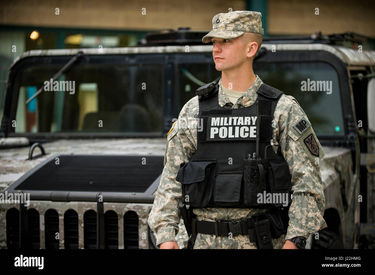 Pfc. Stephen Grams, U.S. Army Reserve military police Soldier from the  200th Military Police Command, headquartered at Fort Meade, Md., stands  with a display High Mobility Multipurpose Wheeled Vehicle during a  celebration