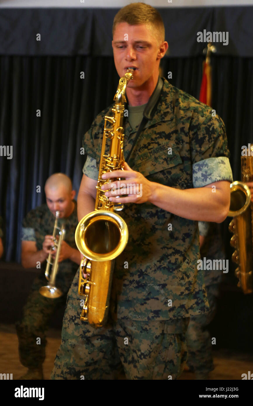 Cpl. Allen West, a saxophone player for the 3rd Marine Aircraft Wing band, plays a solo for the volunteers and guests celebrating the Marine Corps Community Services volunteer appreciation ceremony at Marine Corps Air Station Miramar, April 19. This year’s volunteer service celebration recognized the selfless acts of over 100 volunteers from around MCAS Miramar and the surrounding community. (Marine Corps photo by Sgt. David Bickel/Released) Stock Photo