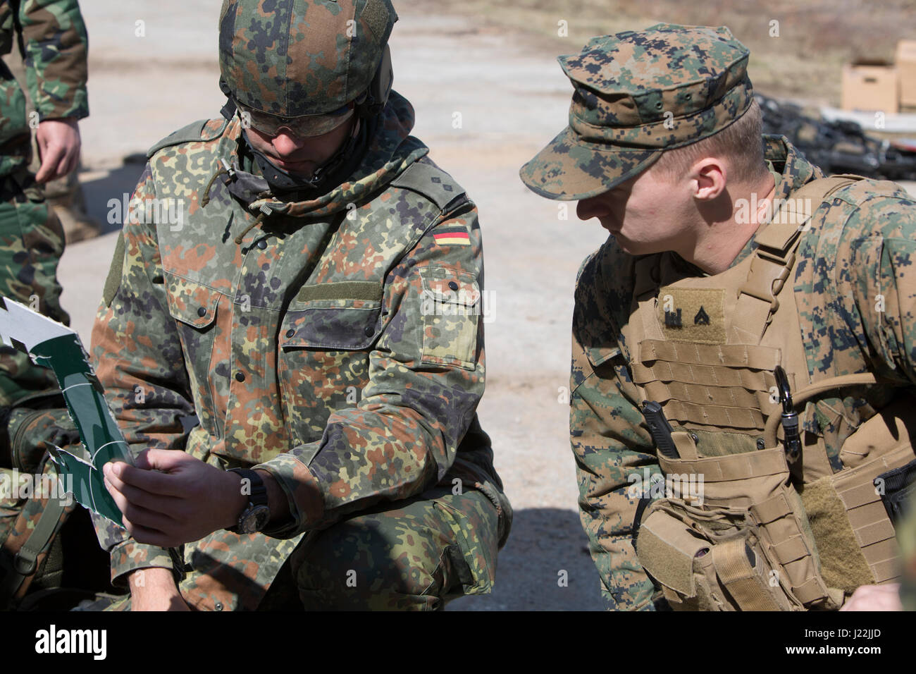 A U.S. Marine with Black Sea Rotational Force 17.1 and a German soldier exchange charge patterns used in everyday practice while participating in breach training during Exercise Summer Shield aboard Adazi Military Base, Latvia, April 20, 2017. Exercise Summer Shield is a multinational NATO exercise. (U.S. Marine Corps photo by Sgt. Patricia A. Morris) Stock Photo