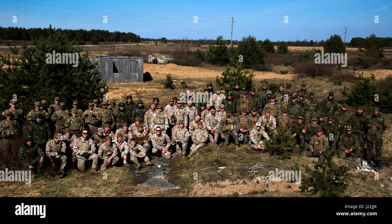 U.S. Marines with Black Sea Rotational Force 17.1 and NATO Allies pose for a photo during breach training during Exercise Summer Shield aboard Adazi Military Base, Latvia, April 20, 2017. Exercise Summer Shield is a multinational NATO exercise. (U.S. Marine Corps photo by Sgt. Patricia A. Morris) Stock Photo