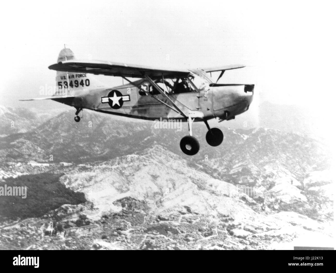 An undated aerial photo of a Stinson L-5 wearing US Air Force markings most likely taken over Korea during the Korean War where the aircraft performed liaison missions and air-ambulance missions. Photo courtesy of the Tinker AFB History Office. Stock Photo