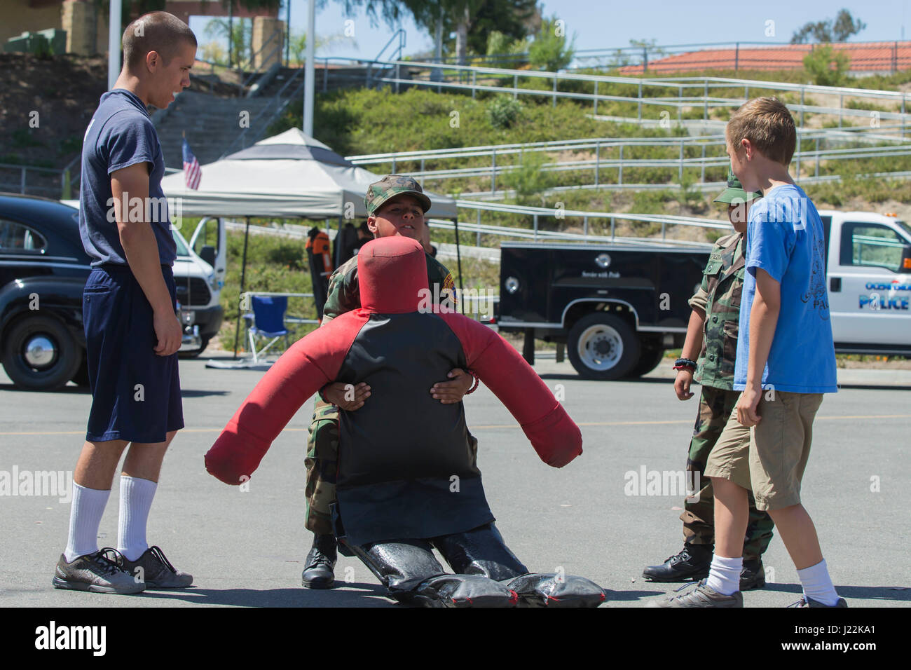 Recruits with the 51st Fire Academy, coach children trying to drag a dummy during the 1st Annual City of Oceanside Public Safety Fair at El Camino High School football field in Oceanside, Calif., April 22, 2017. (U.S. Marine Corps photo by Lance Cpl. Brooke Woods) Stock Photo