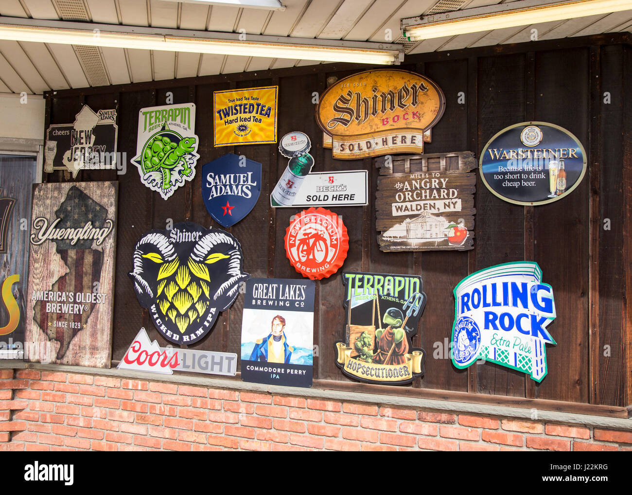 Signs showing different brands of beer in front of a liquor store in Ramsey, New Jersey Stock