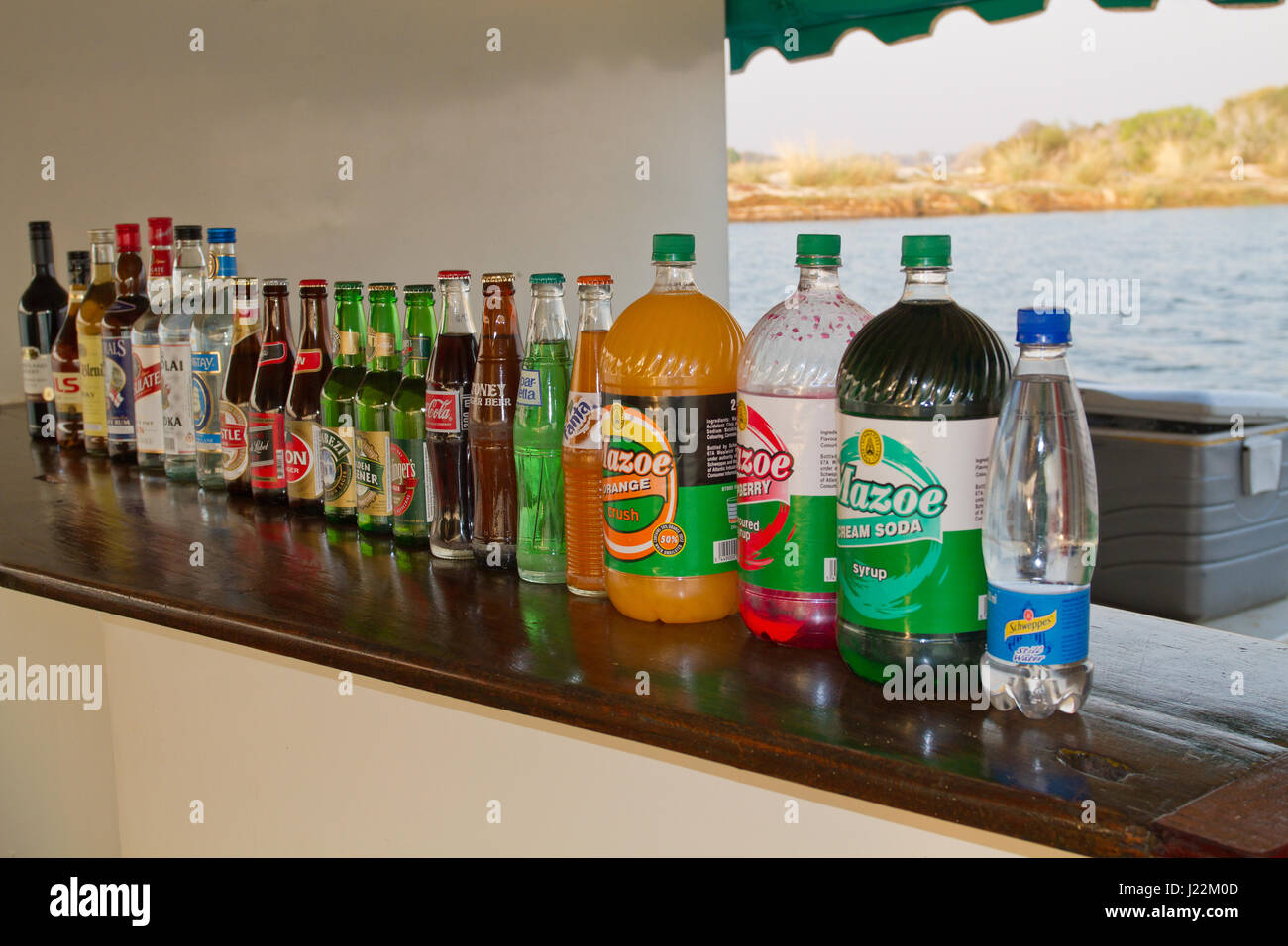 Countertop with an assortment of alcoholic and non-alcoholic drinks available on a sundowner cruise on the Zambezi River, Zimbabwe, Africa Stock Photo