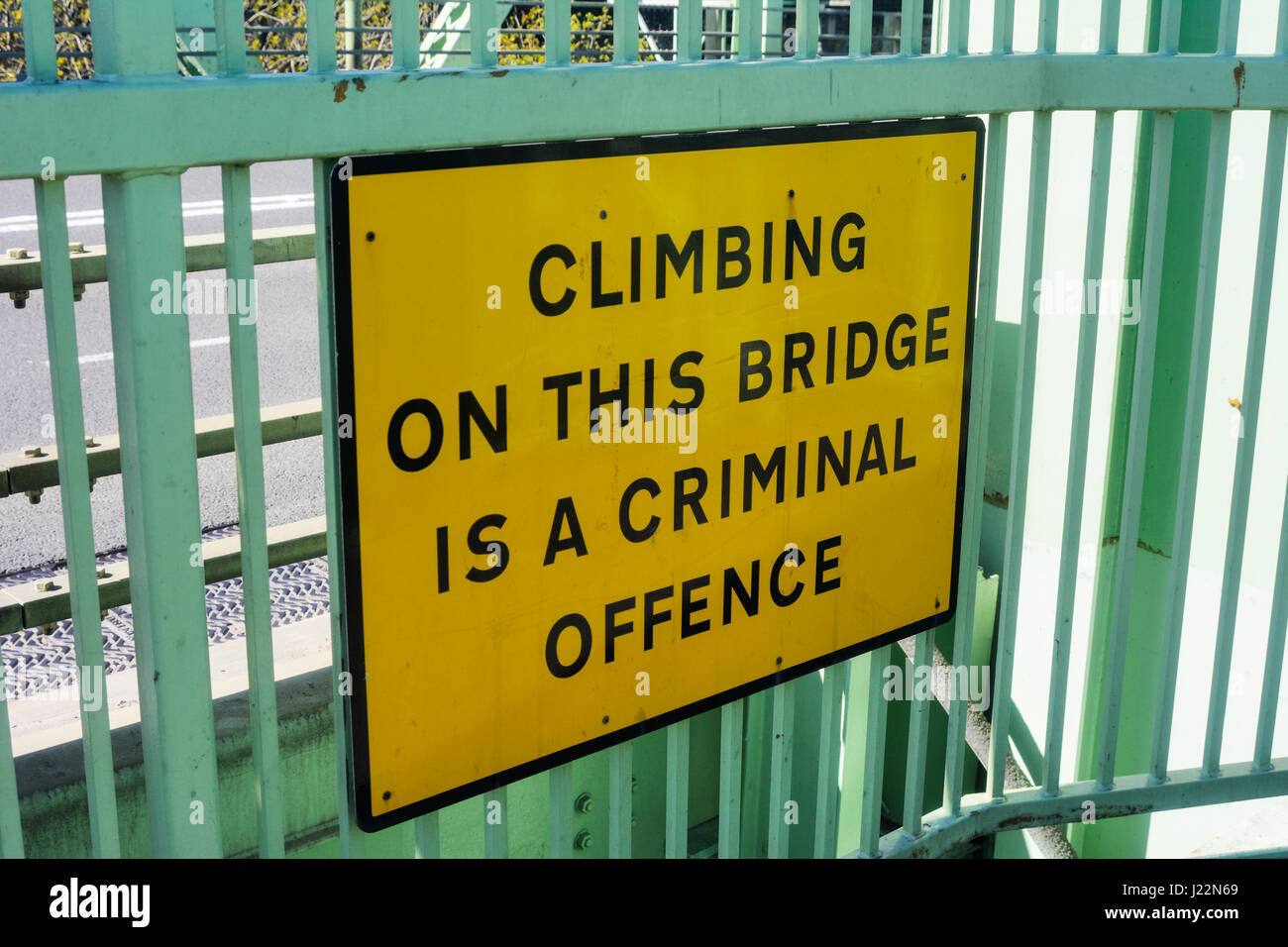 Warning sign attached to Runcorn Bridge stating it is a criminal offence to climb on the bridge structure. Stock Photo