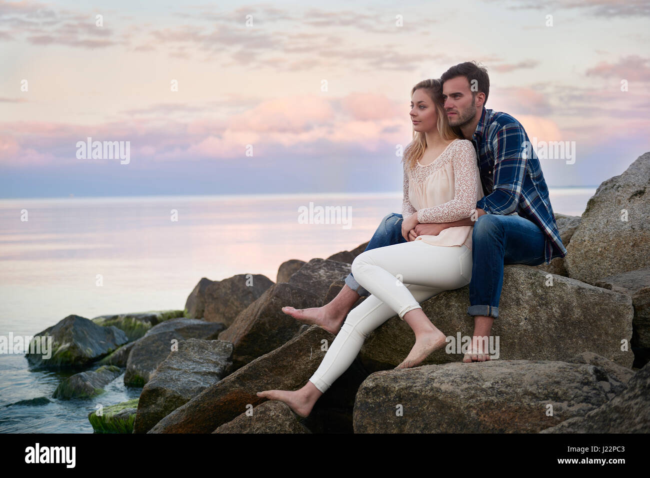 Relaxing couple on the rocks Stock Photo - Alamy