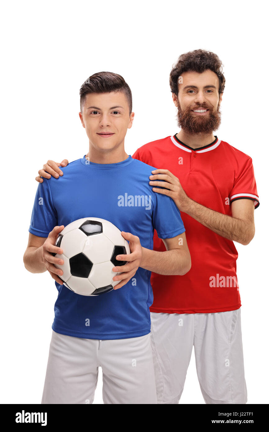 Proud father with his son dressed in sport jerseys looking at the camera isolated on white background Stock Photo