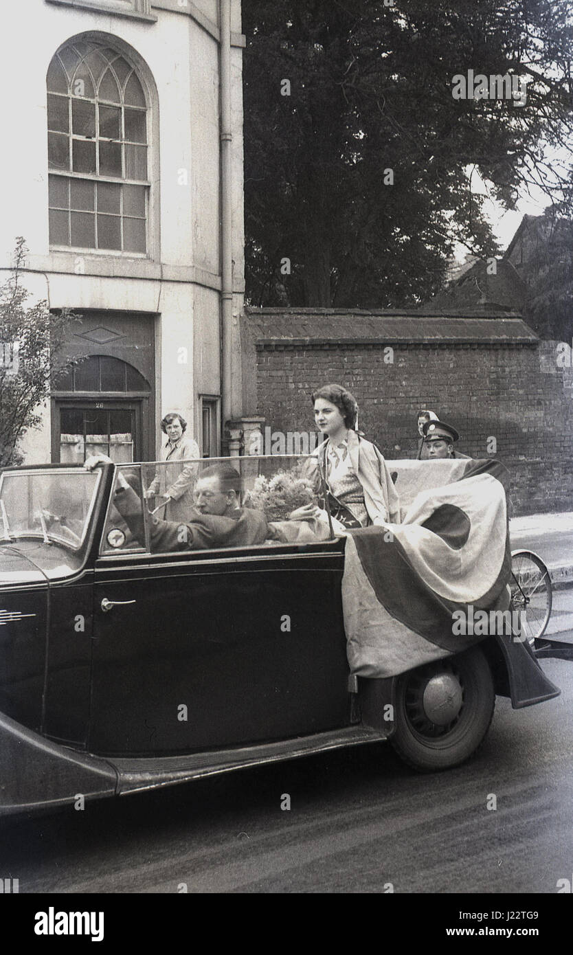 1950s, Miss Astria, winner of the Royal Air Forces Association (RAFA) beauty pageant sitting in an open top car in a public parade, England, UK. Stock Photo
