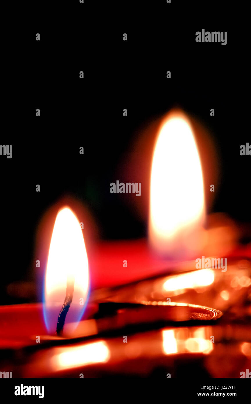 flickering candle flames against black Stock Photo Alamy