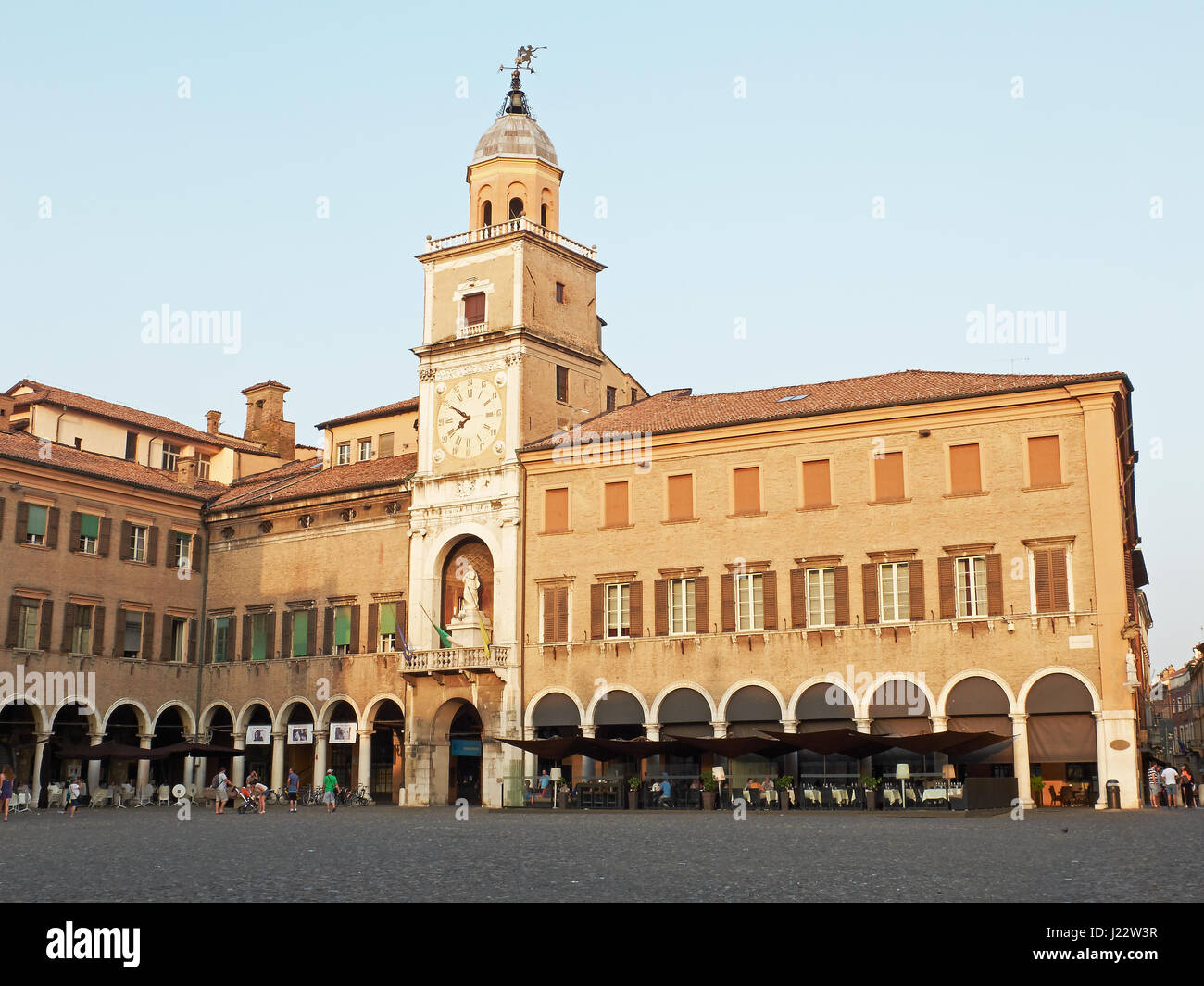 Torre delle Orologio, Clock tower, of Palazzo Comunale, city hall, in Piazza Grande of Modena at sunset. Emilia-Romagna. Italy Stock Photo
