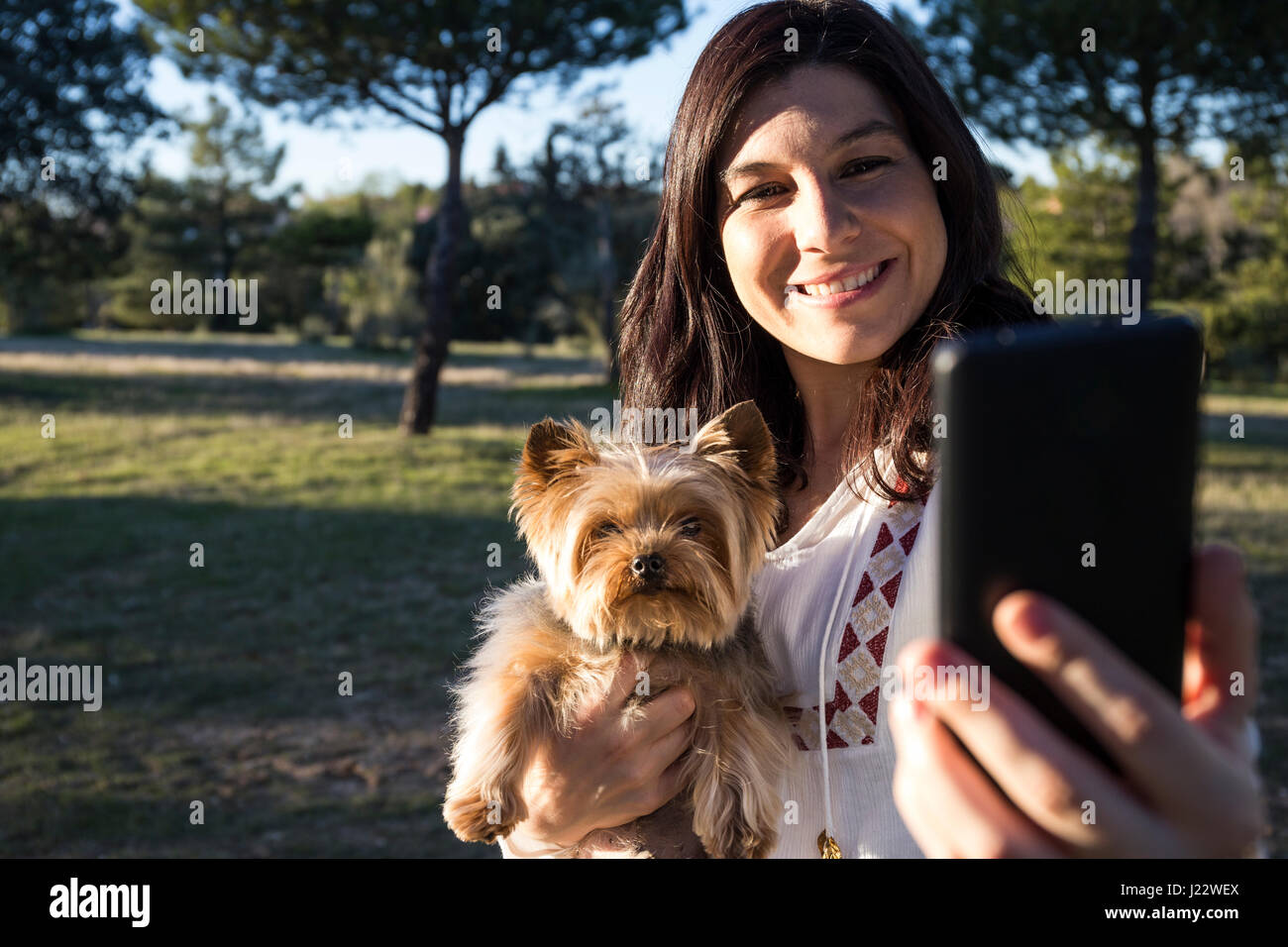 Happy young woman taking selfie with her dog Stock Photo - Alamy